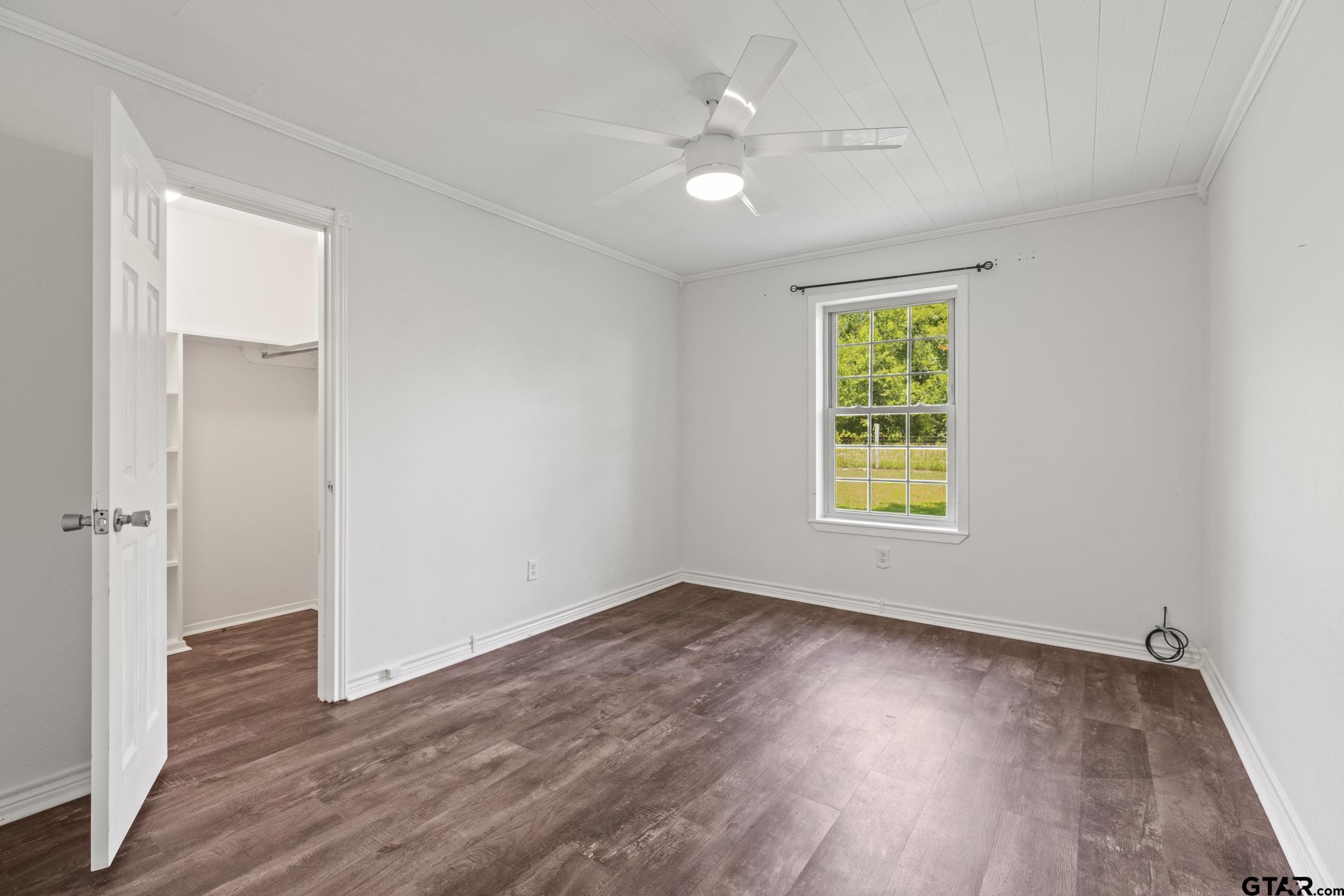 22741 County Road 448 Lindale, TX 75771 - Photo 25 of 48 an empty room with wooden floor chandelier fan and windows