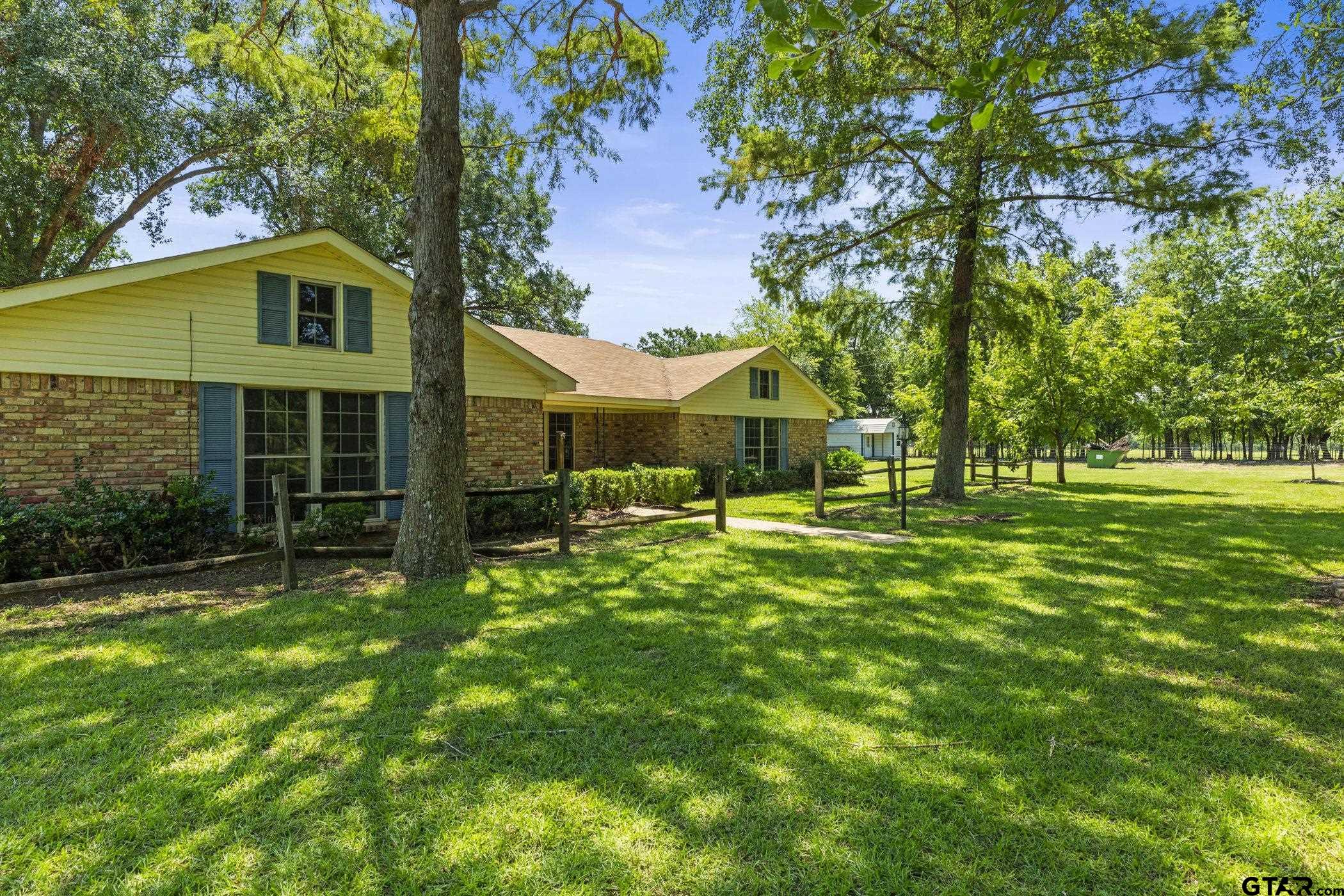 22741 County Road 448 Lindale, TX 75771 - Photo 3 of 48 a backyard of a house with table and chairs