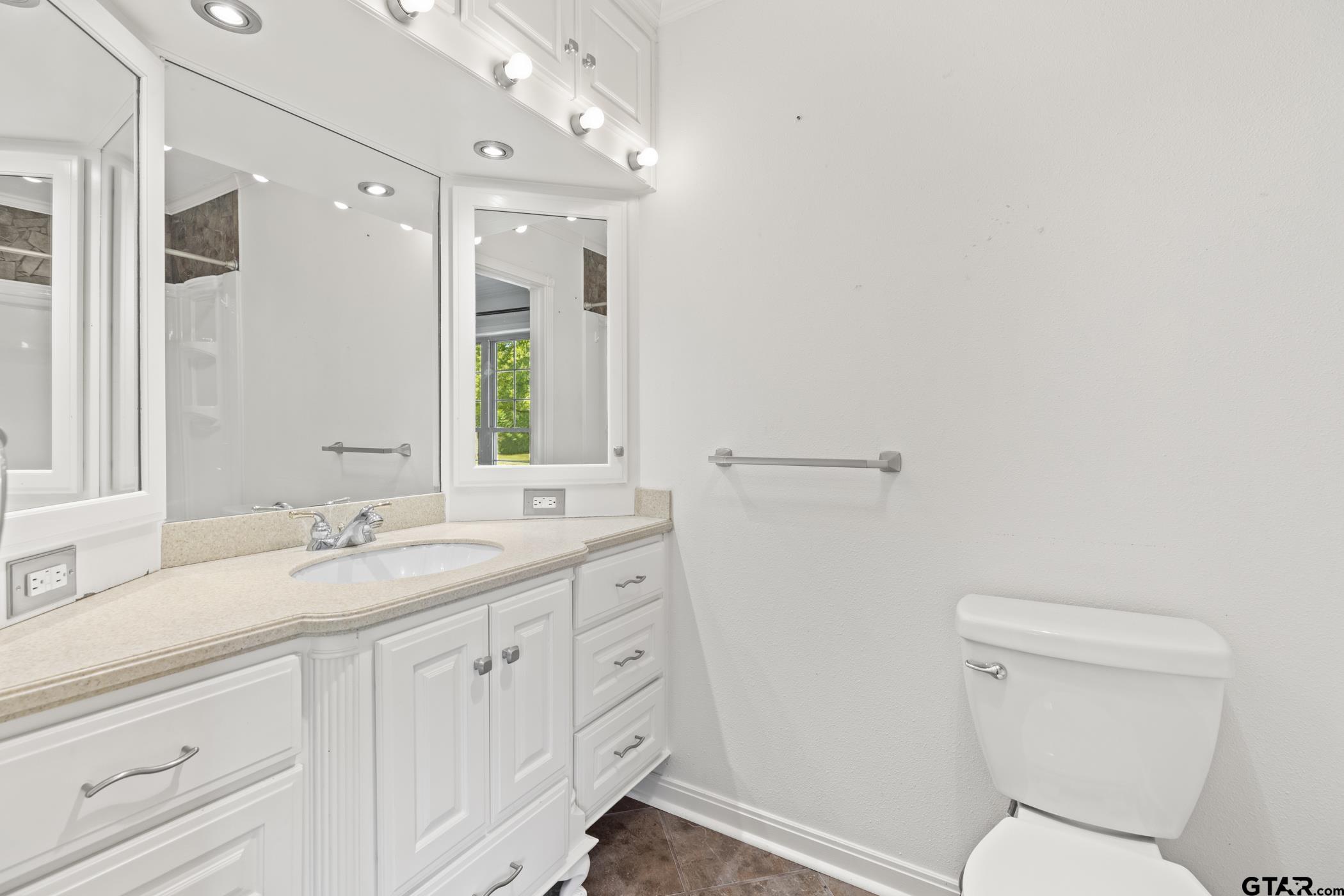 22741 County Road 448 Lindale, TX 75771 - Photo 31 of 48 a bathroom with a granite countertop toilet sink and mirror