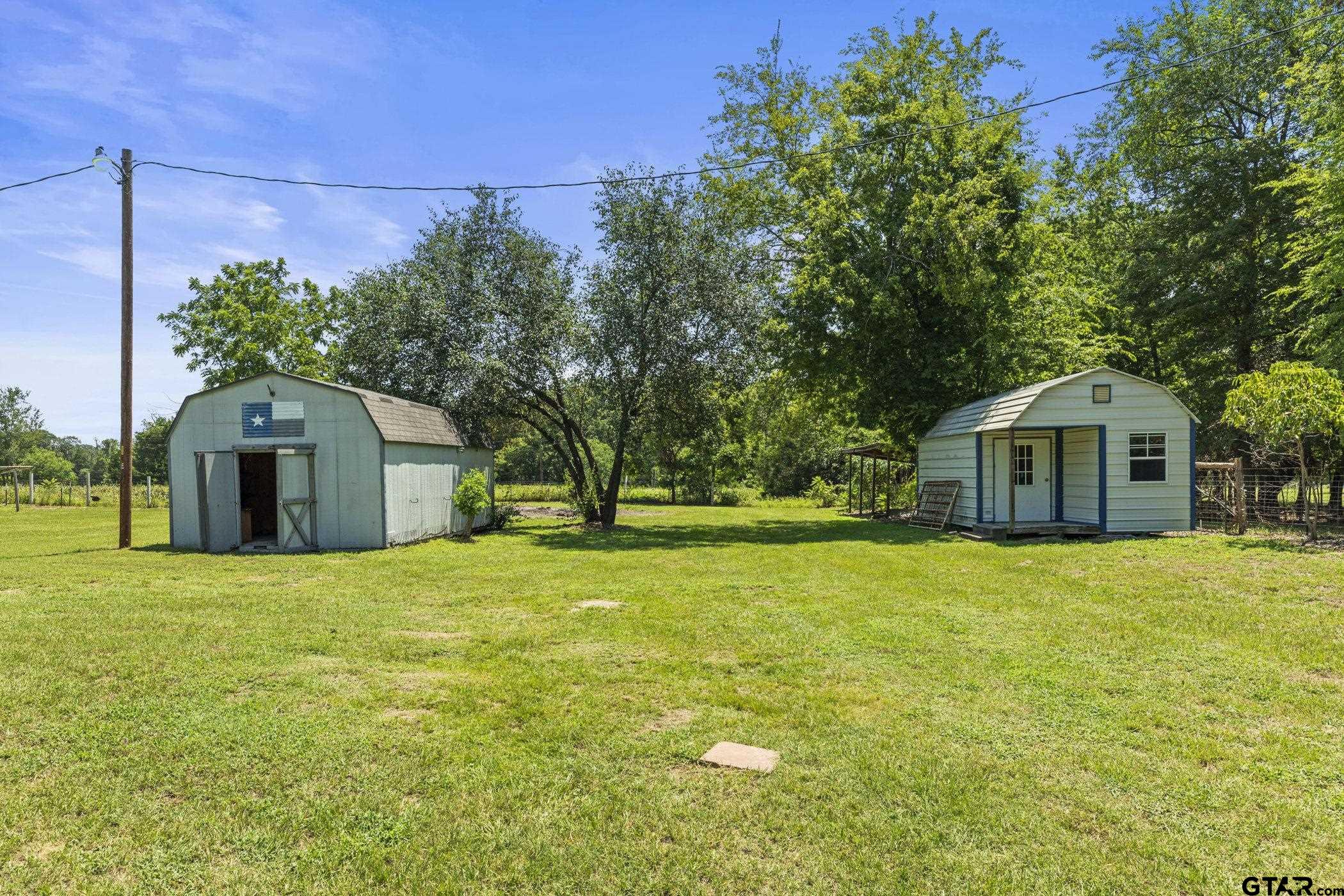 22741 County Road 448 Lindale, TX 75771 - Photo 6 of 48 a front view of a house with a yard and garage