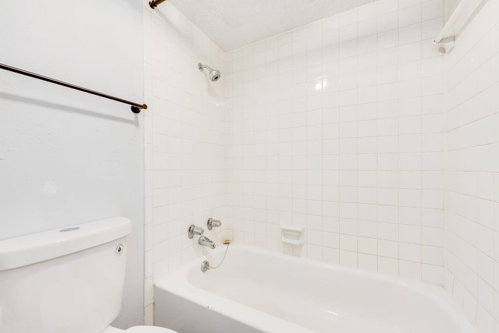 5514 Boca Raton Boulevard, Unit 438 Fort Worth, TX 76112 - Photo 14 of 25 a bathroom with a bathtub and shower