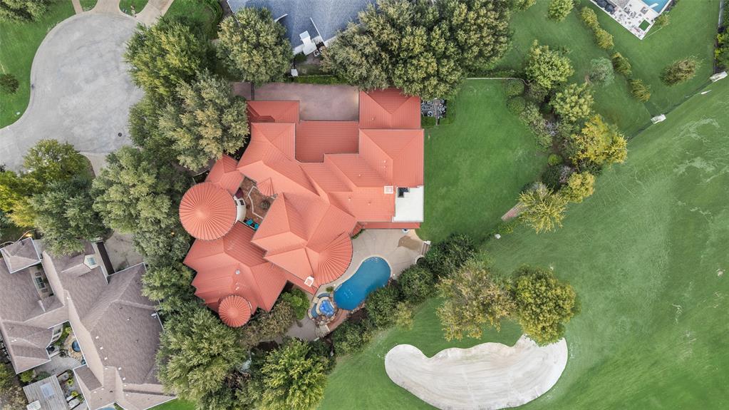 an aerial view of a house with a yard and trees