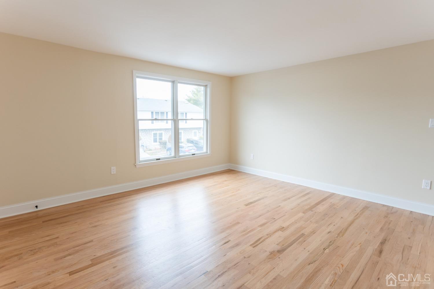 5004 Hana Road Edison, NJ 08817 - Photo 29 of 29 a view of an empty room with wooden floor and a window