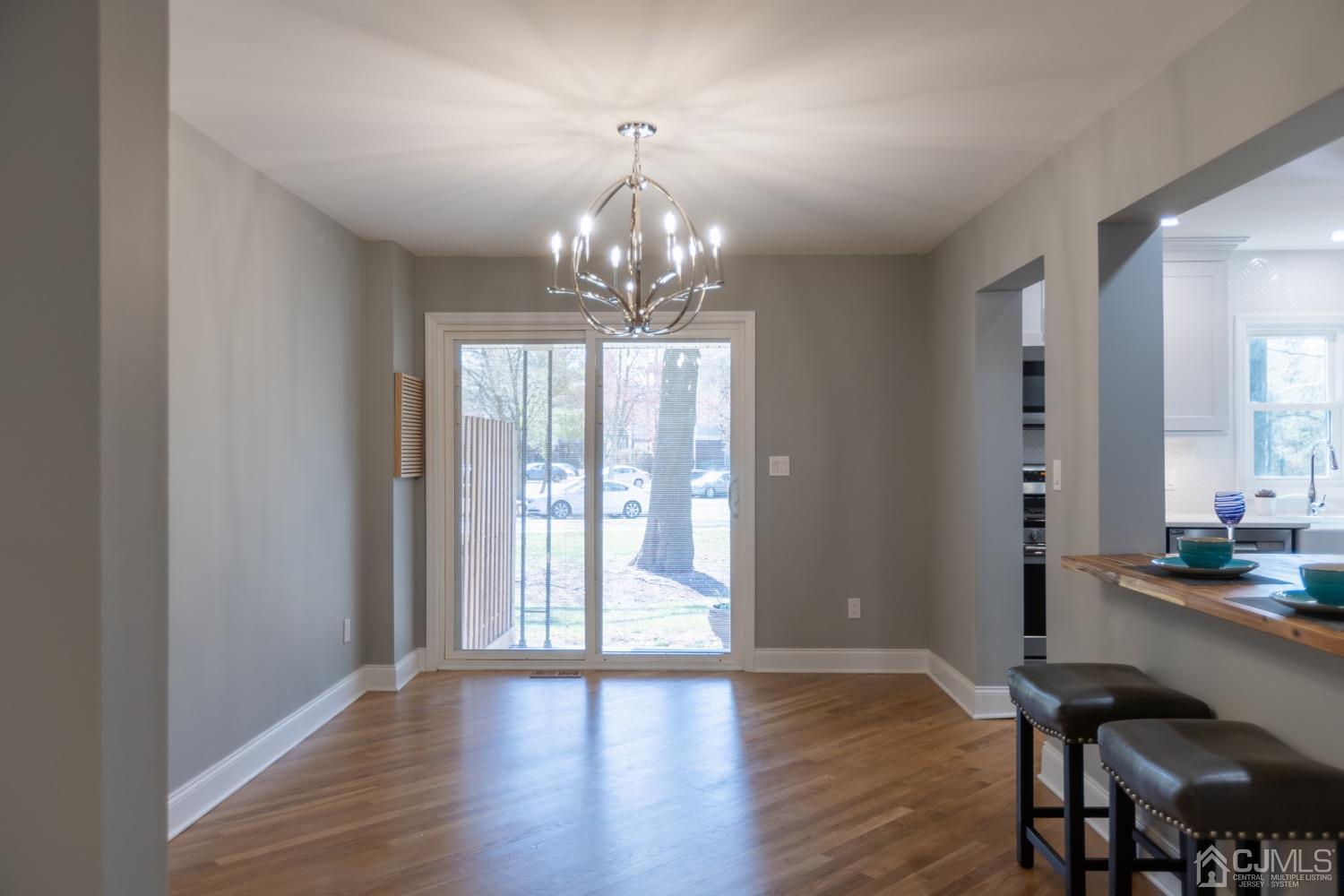 5004 Hana Road Edison, NJ 08817 - Photo 6 of 29 a view of a room with wooden floor and chandelier