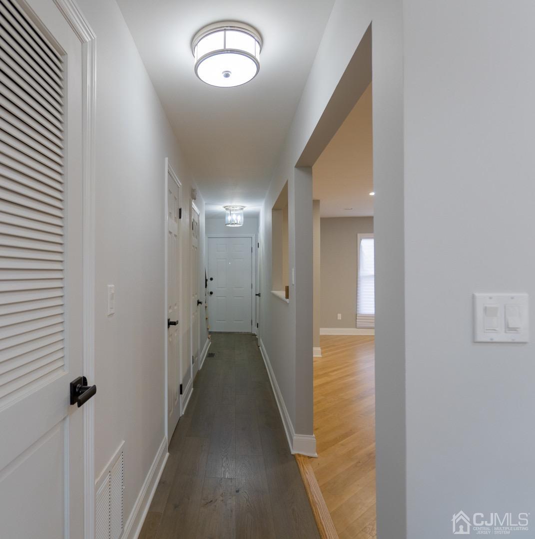 5004 Hana Road Edison, NJ 08817 - Photo 8 of 29 a view of a hallway with wooden floor
