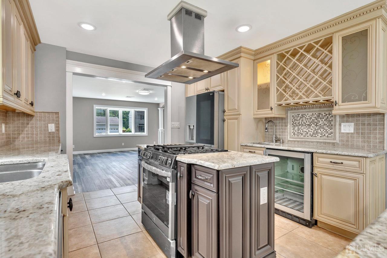 114 Morningside Road Colonia, NJ 07067 - Photo 11 of 27 a kitchen that has a sink a stove and a wooden floor