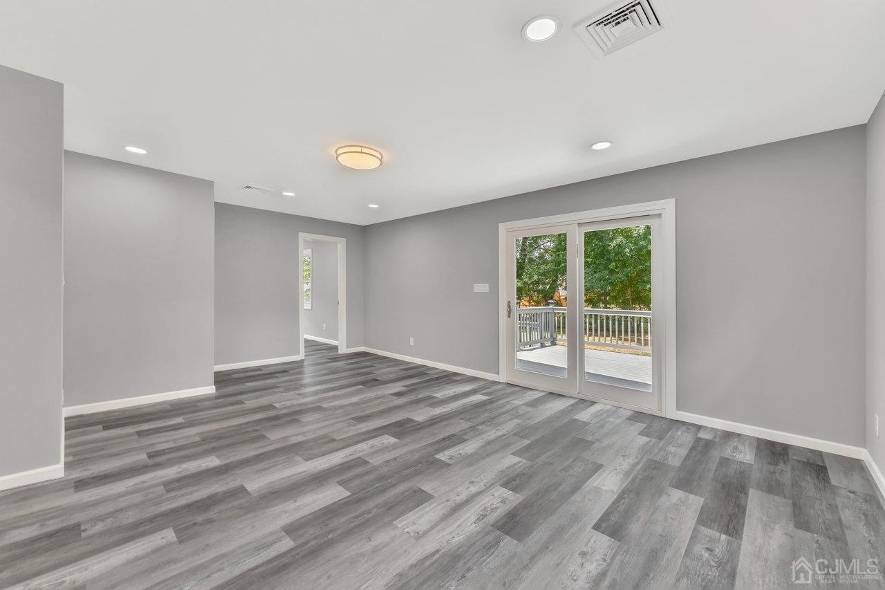 114 Morningside Road Colonia, NJ 07067 - Photo 12 of 27 a view of an empty room with wooden floor and a window