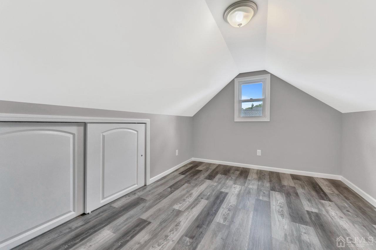 114 Morningside Road Colonia, NJ 07067 - Photo 21 of 27 an empty room with wooden floor and windows