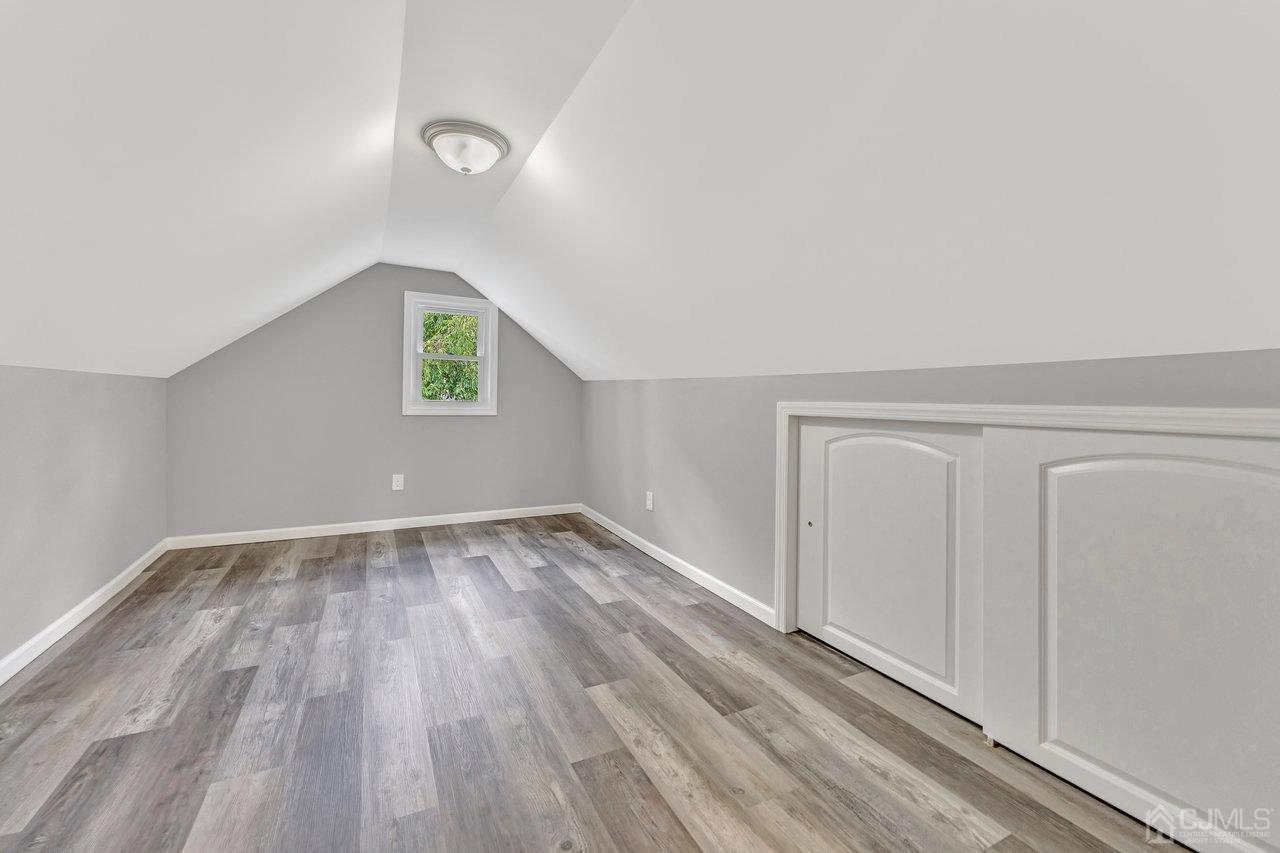 114 Morningside Road Colonia, NJ 07067 - Photo 22 of 27 a view of an empty room with wooden floor and a window
