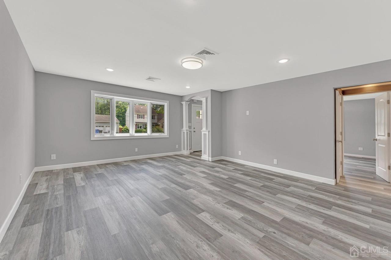 114 Morningside Road Colonia, NJ 07067 - Photo 8 of 27 a view of empty room with wooden floor and fan