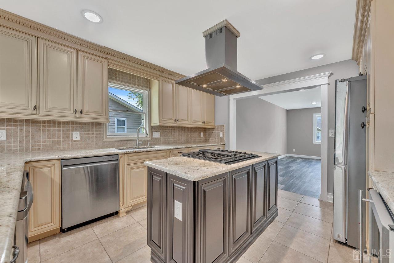 114 Morningside Road Colonia, NJ 07067 - Photo 10 of 27 a kitchen with a stove sink and cabinets