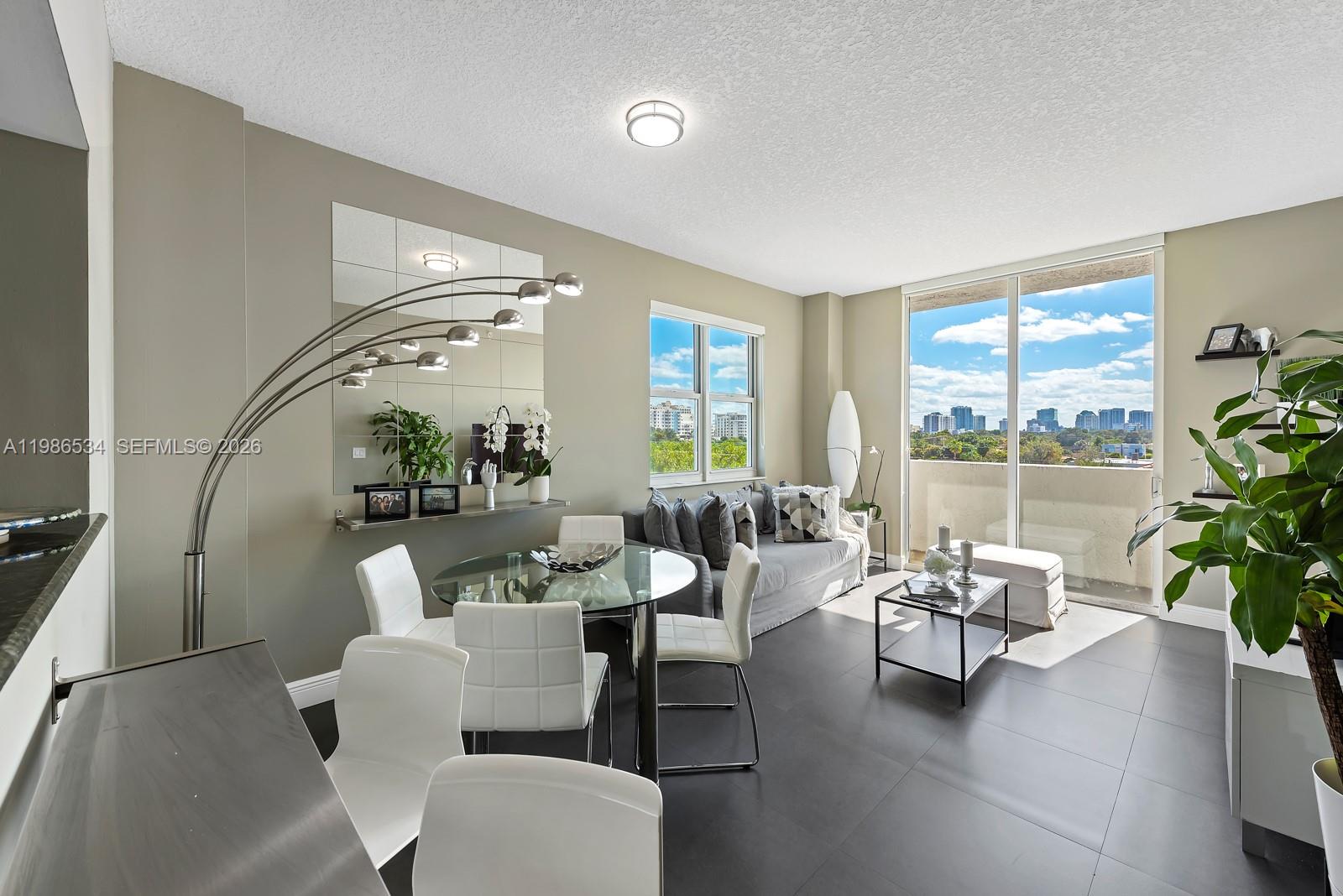 3000 Coral Way, Unit 416 Miami, FL 33145 - Photo 1 of 23 a living room with furniture and a large window