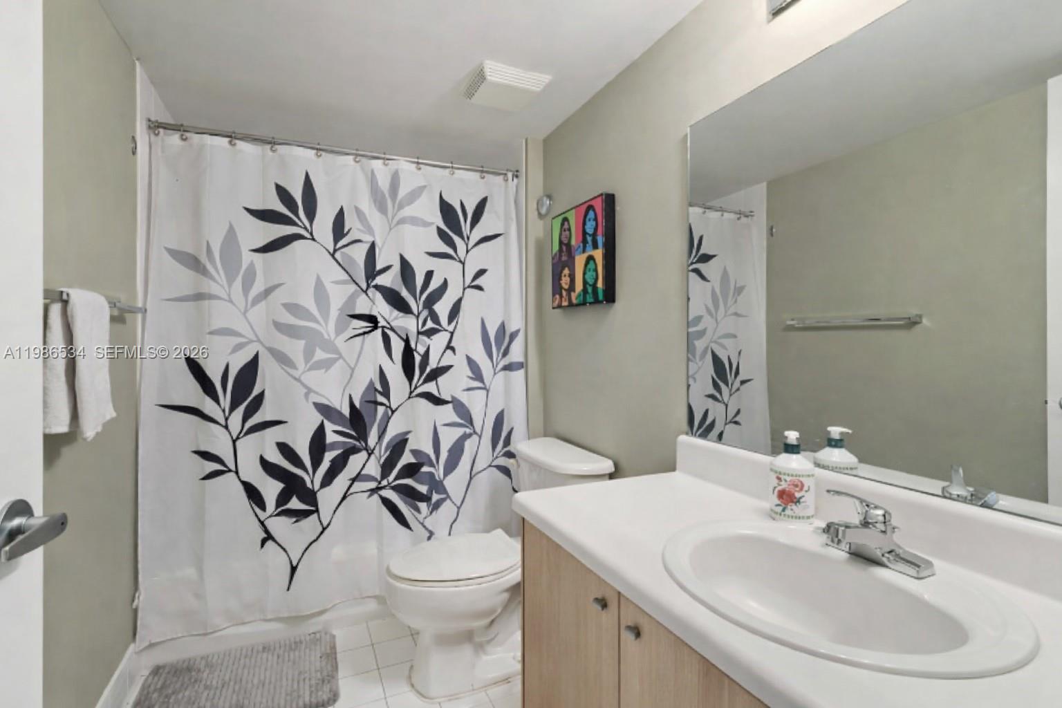 3000 Coral Way, Unit 416 Miami, FL 33145 - Photo 11 of 23 a bathroom with a white toilet sink and shower curtain