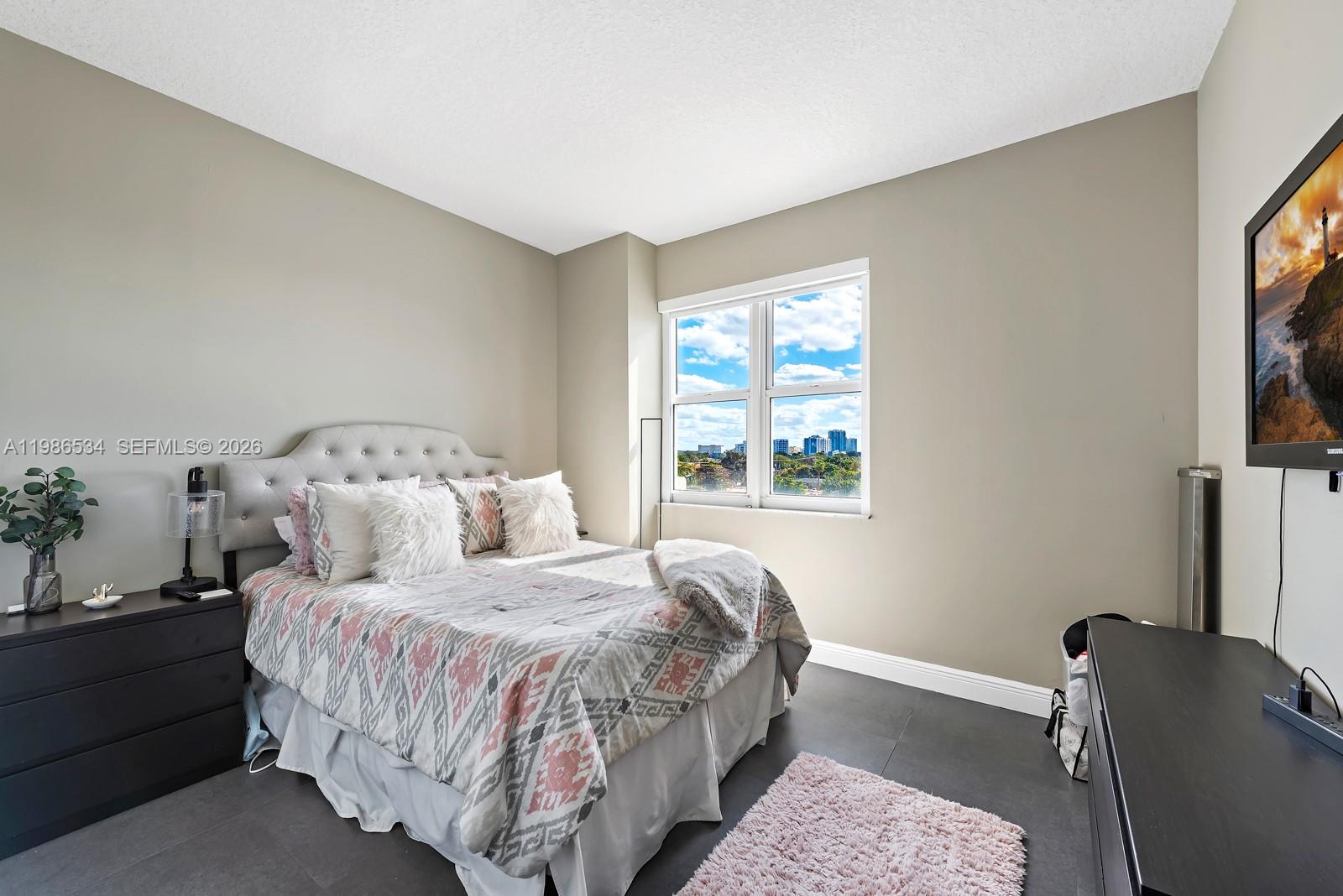 3000 Coral Way, Unit 416 Miami, FL 33145 - Photo 12 of 23 a bed sitting in a bedroom next to a window