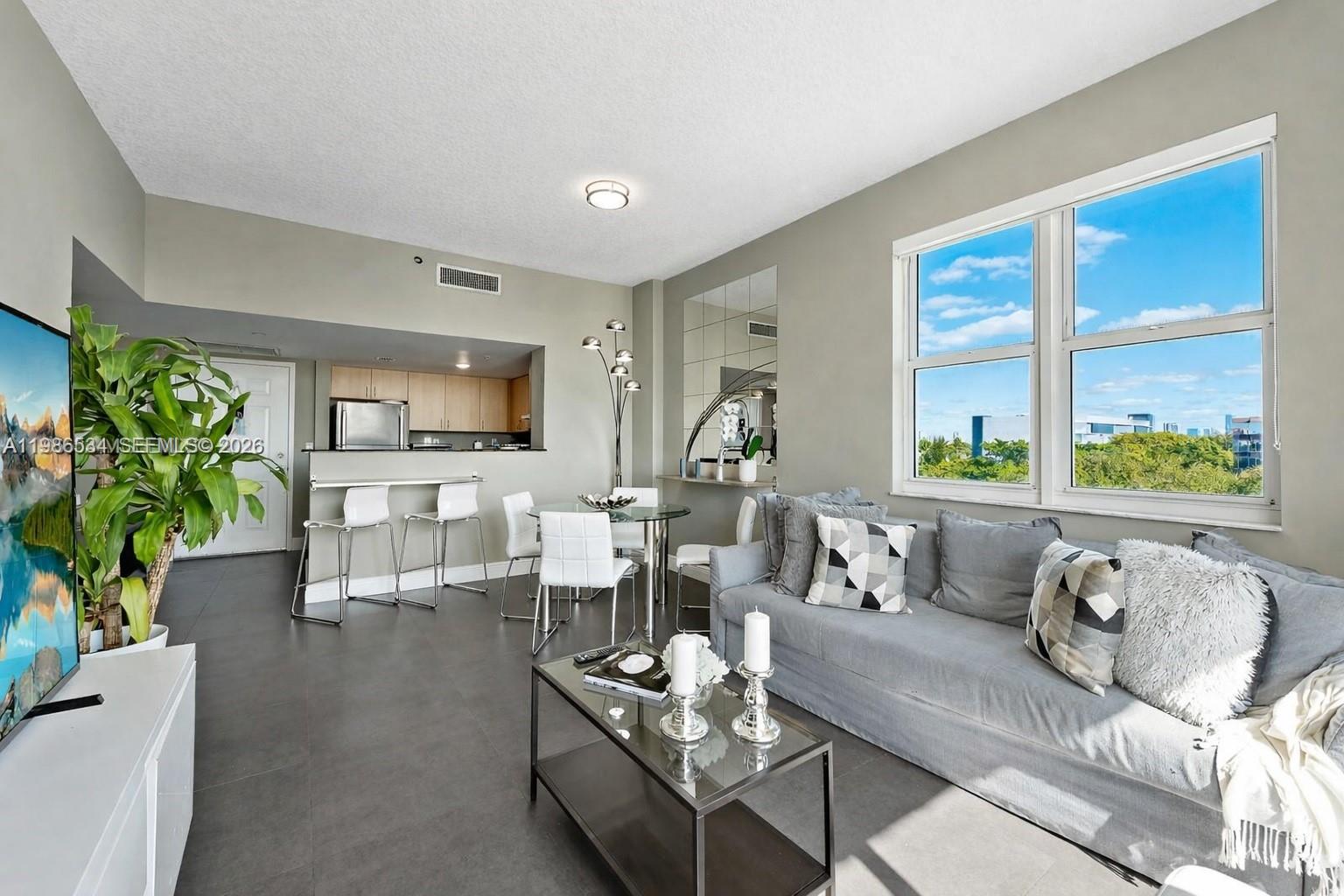 3000 Coral Way, Unit 416 Miami, FL 33145 - Photo 4 of 23 a living room with furniture and a large window