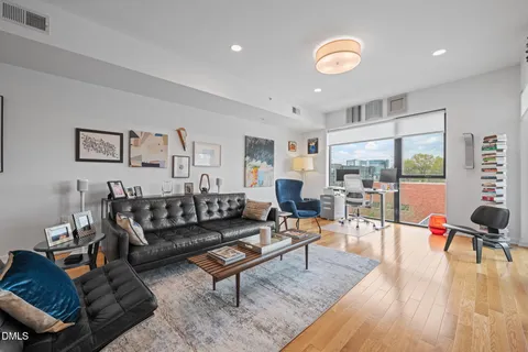 a living room with furniture and wooden floor