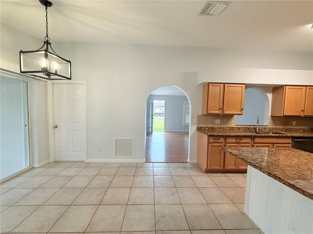27595 Imperial River Road Bonita Springs, FL 34134 - Photo 11 of 28 a kitchen with stainless steel appliances granite countertop a sink and cabinets