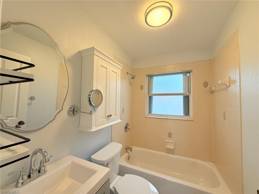 27595 Imperial River Road Bonita Springs, FL 34134 - Photo 16 of 28 a bathroom with a sink a toilet and a mirror