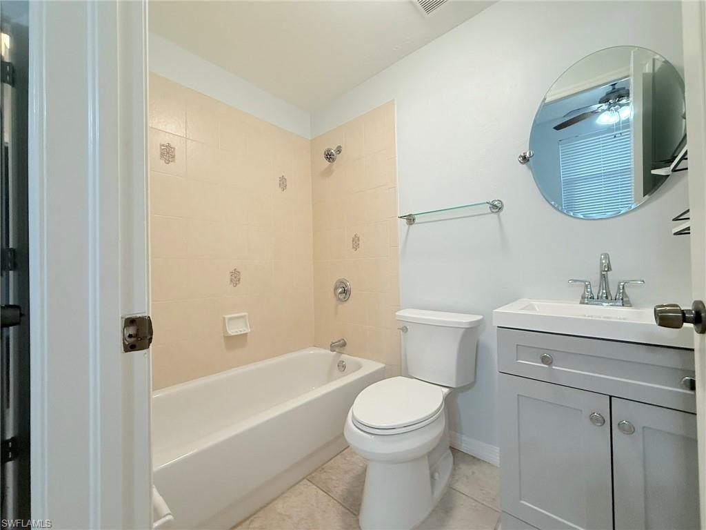 27595 Imperial River Road Bonita Springs, FL 34134 - Photo 21 of 28 a bathroom with a toilet a sink a mirror a bathtub and vanity