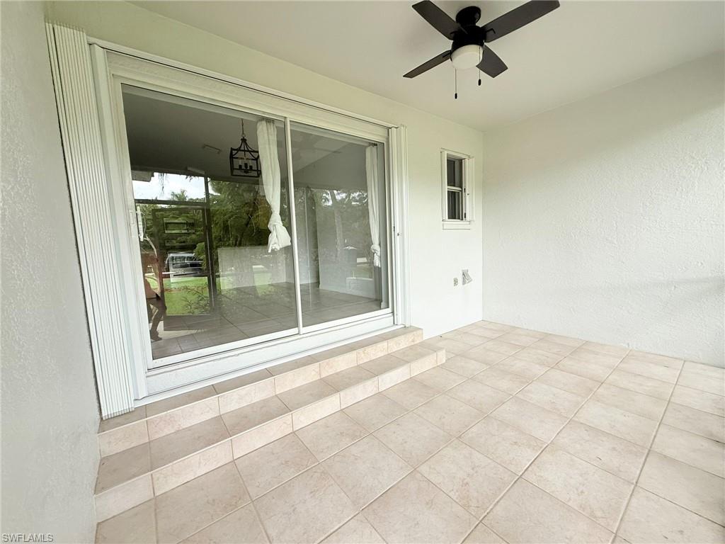27595 Imperial River Road Bonita Springs, FL 34134 - Photo 24 of 28 a view of a hallway with a glass door