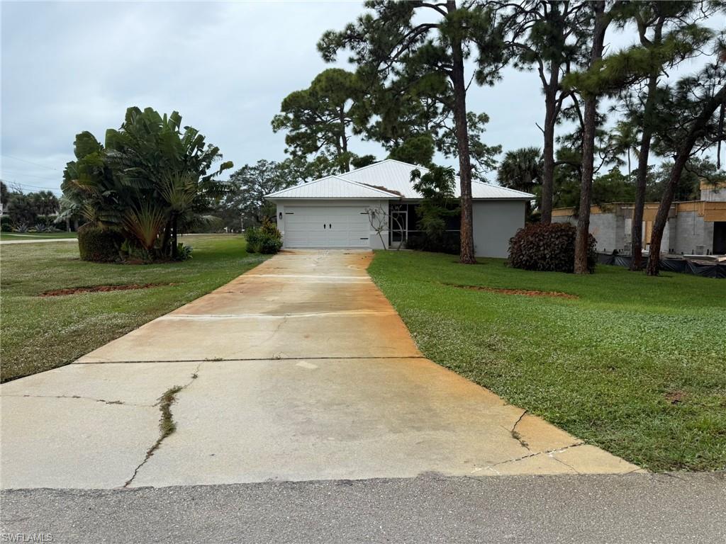 27595 Imperial River Road Bonita Springs, FL 34134 - Photo 27 of 28 a white bench sitting in the middle of a park