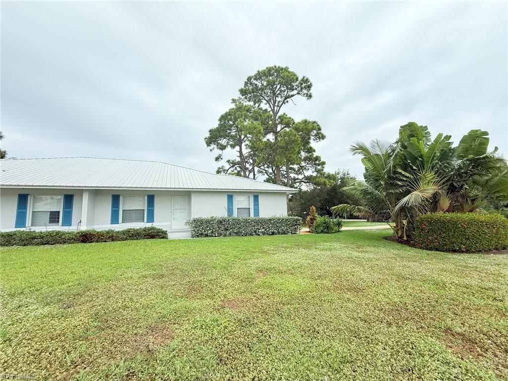 27595 Imperial River Road Bonita Springs, FL 34134 - Photo 3 of 28 a house view with a garden space