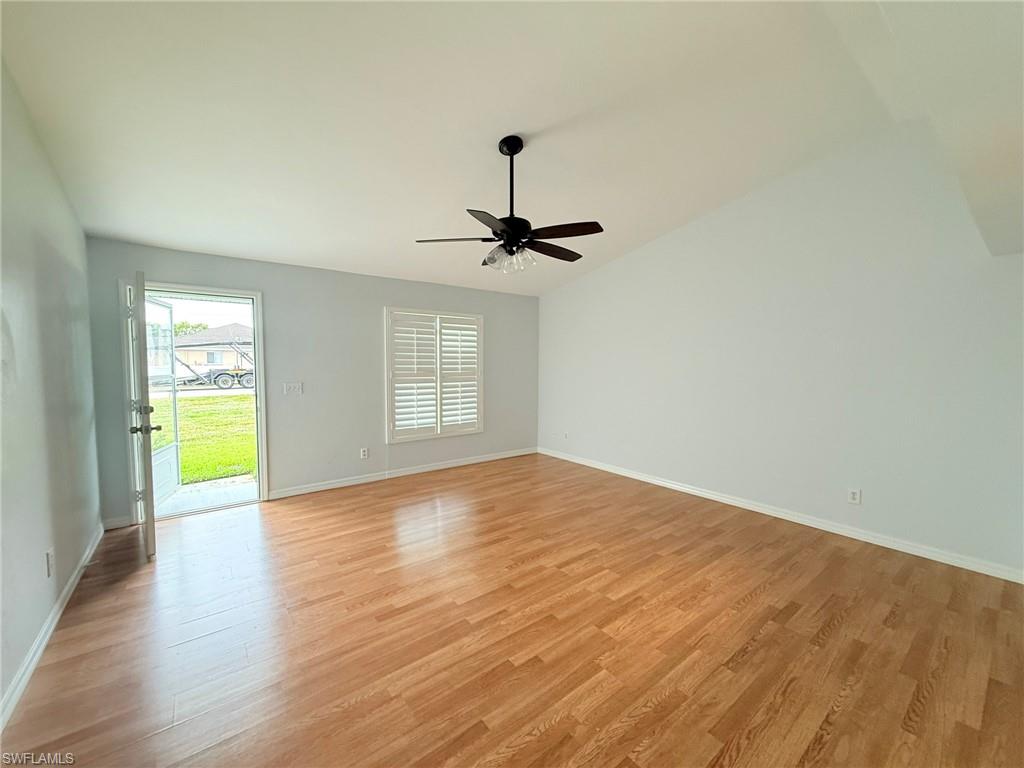 27595 Imperial River Road Bonita Springs, FL 34134 - Photo 8 of 28 a view of an empty room with a window and wooden floor