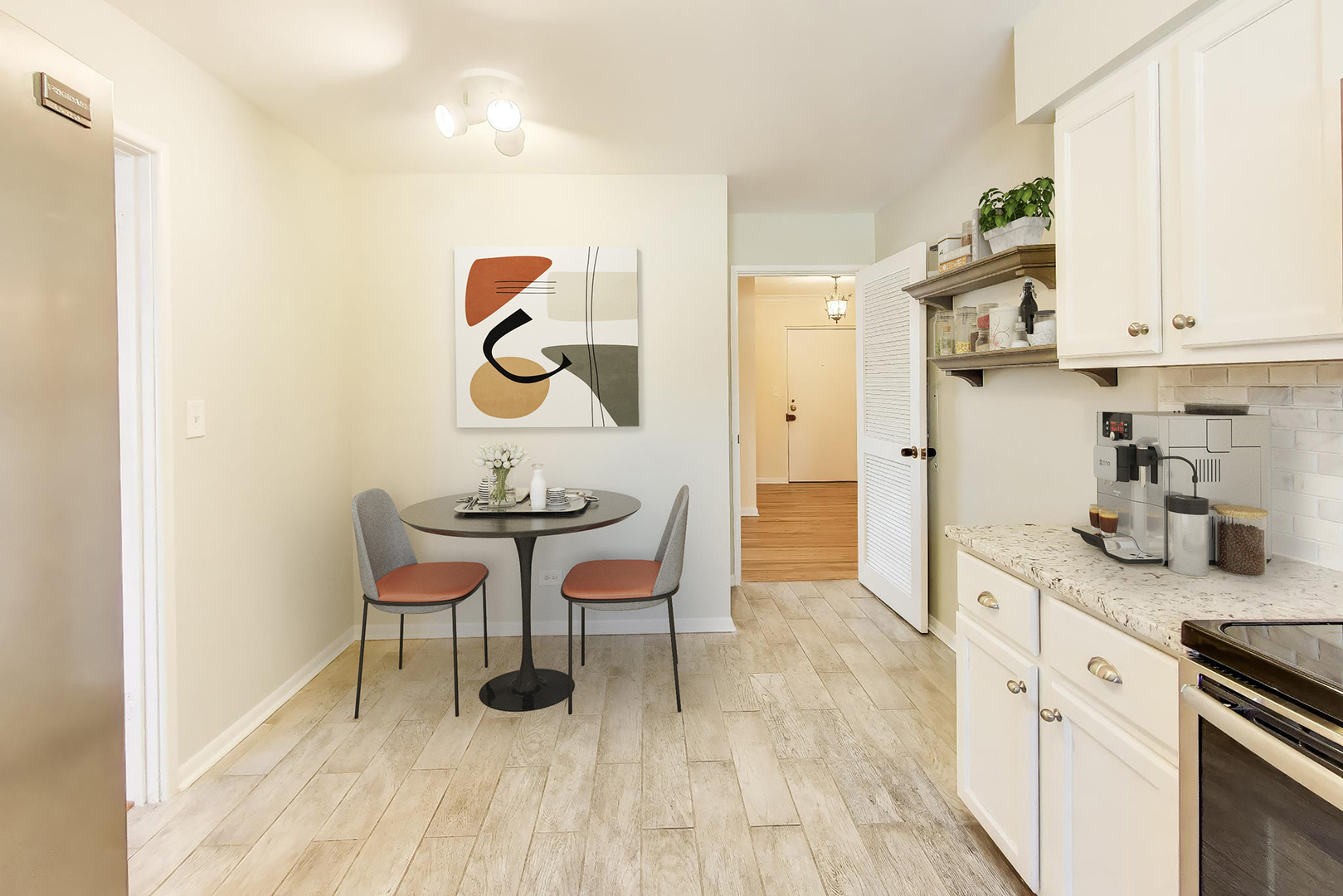 2324 Central Street, Unit 2B Evanston, IL 60201 - Photo 13 of 28 a kitchen with stainless steel appliances granite countertop a kitchen island a hardwood floor and a sink