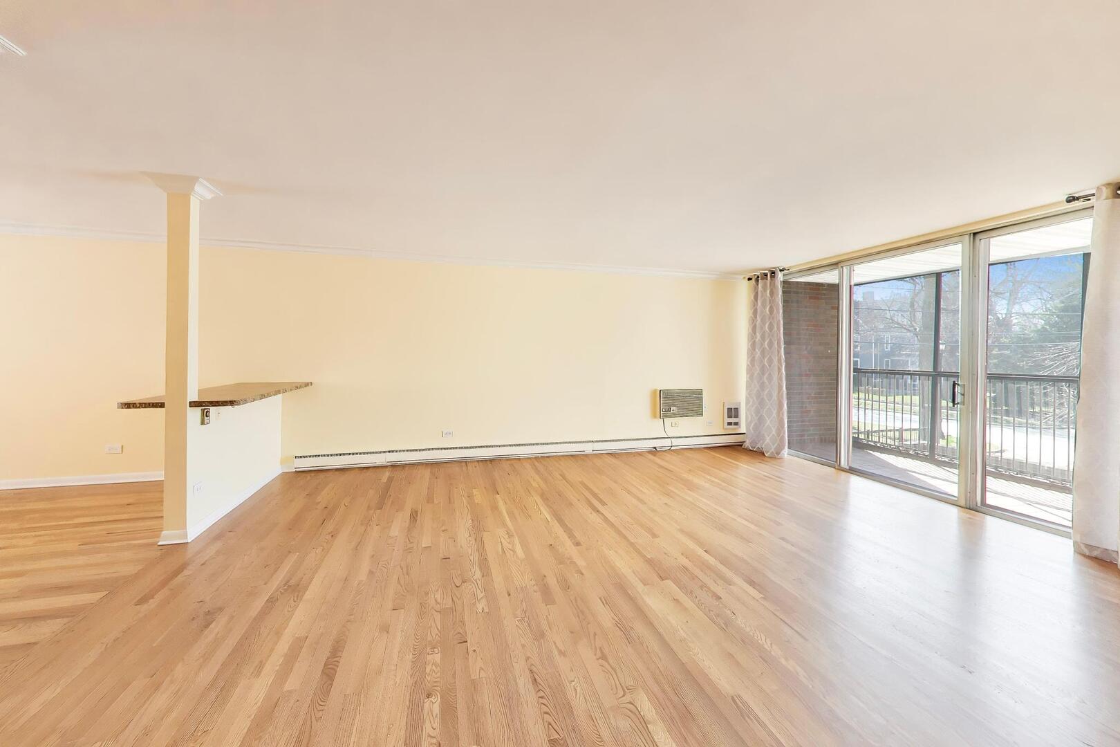 2324 Central Street, Unit 2B Evanston, IL 60201 - Photo 5 of 28 wooden floor in an empty room with a window