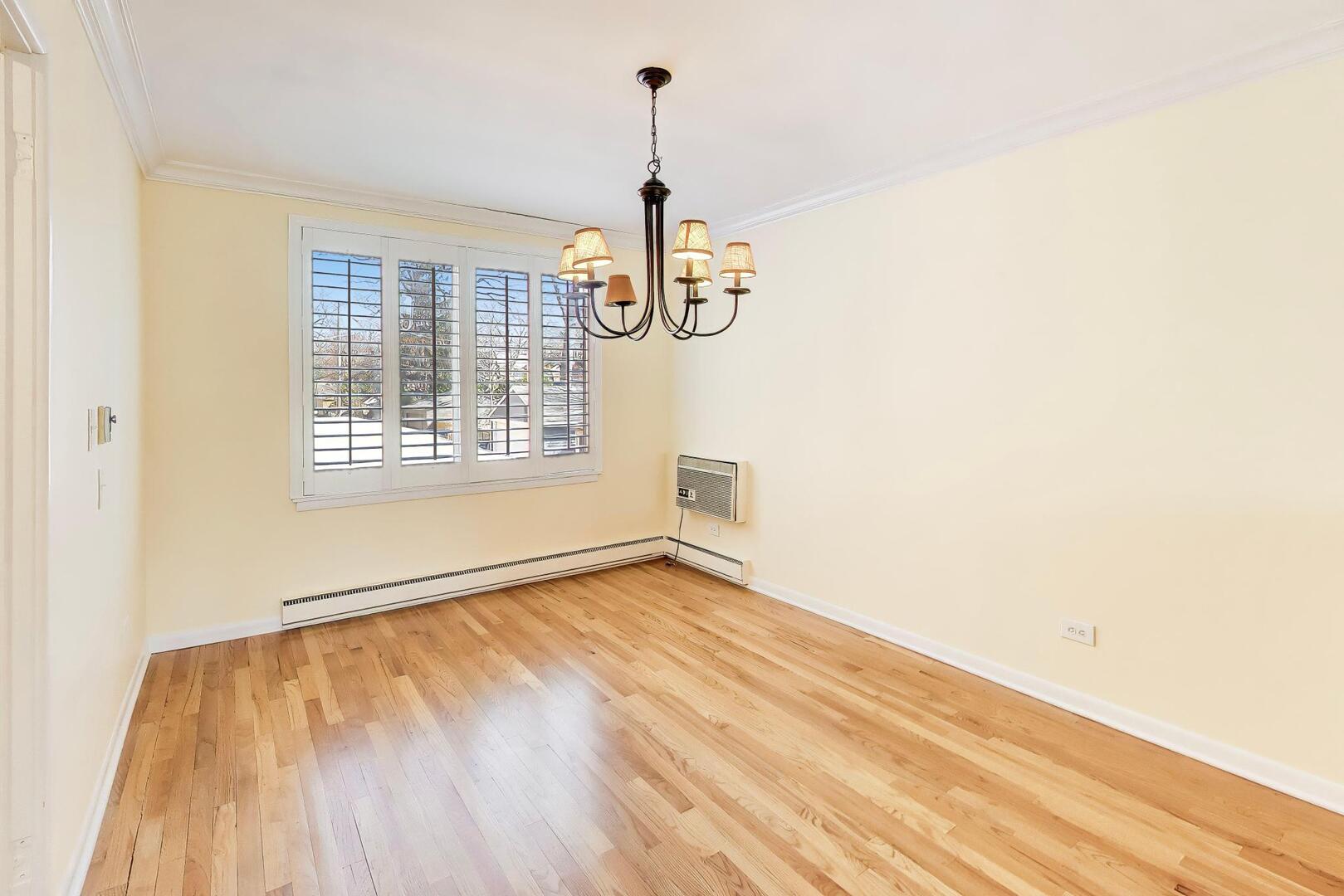 2324 Central Street, Unit 2B Evanston, IL 60201 - Photo 8 of 28 a view of an empty room with wooden floor and a window