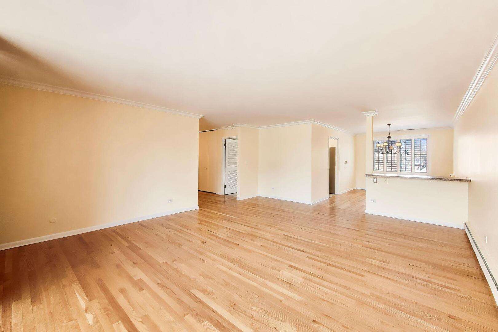 2324 Central Street, Unit 2B Evanston, IL 60201 - Photo 10 of 28 a view of empty room with wooden floor and fan