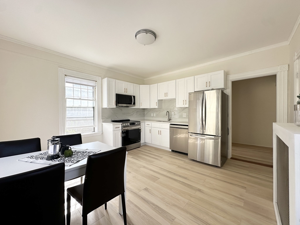 71 A Gardner Street, Unit 2 Boston, MA 02134 - Photo 5 of 13 a kitchen with white cabinets and white appliances