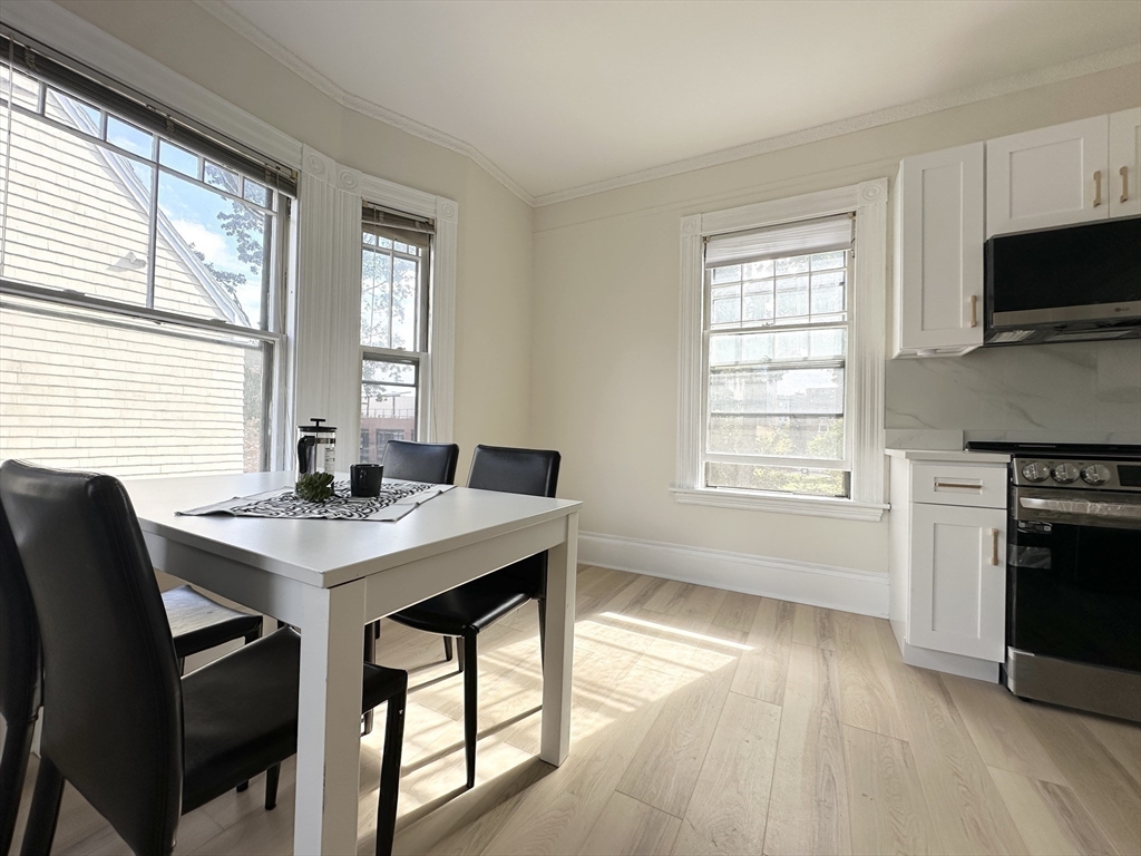 71 A Gardner Street, Unit 2 Boston, MA 02134 - Photo 6 of 13 a view of a dining room with furniture and a window