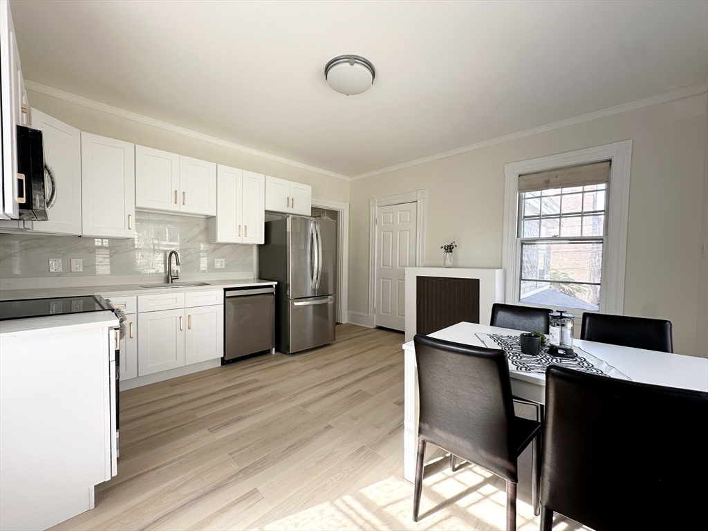 71 A Gardner Street, Unit 2 Boston, MA 02134 - Photo 7 of 13 a kitchen with a refrigerator and a stove top oven
