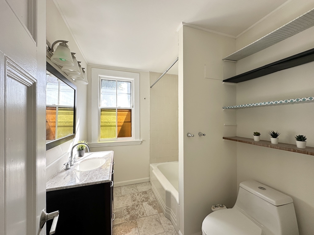 71 A Gardner Street, Unit 2 Boston, MA 02134 - Photo 9 of 13 a bathroom with a sink toilet and shower