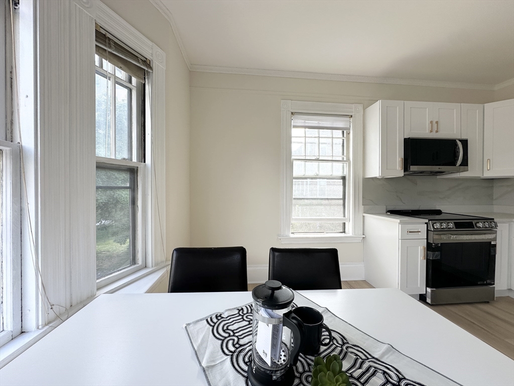 71 A Gardner Street, Unit 2 Boston, MA 02134 - Photo 10 of 13 a bedroom with a bed and a window