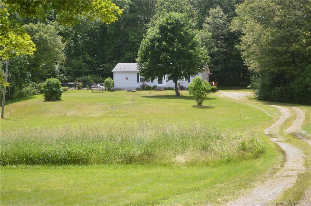 589 Westcott Road Killingly, CT 06239 - Photo 1 of 1 a swimming pool with trees in the background