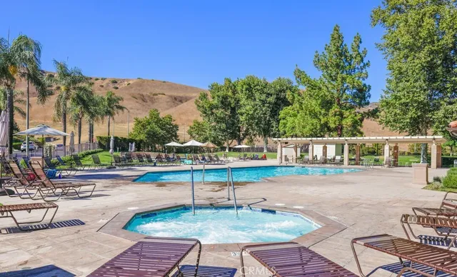 a view of a house with backyard and sitting area