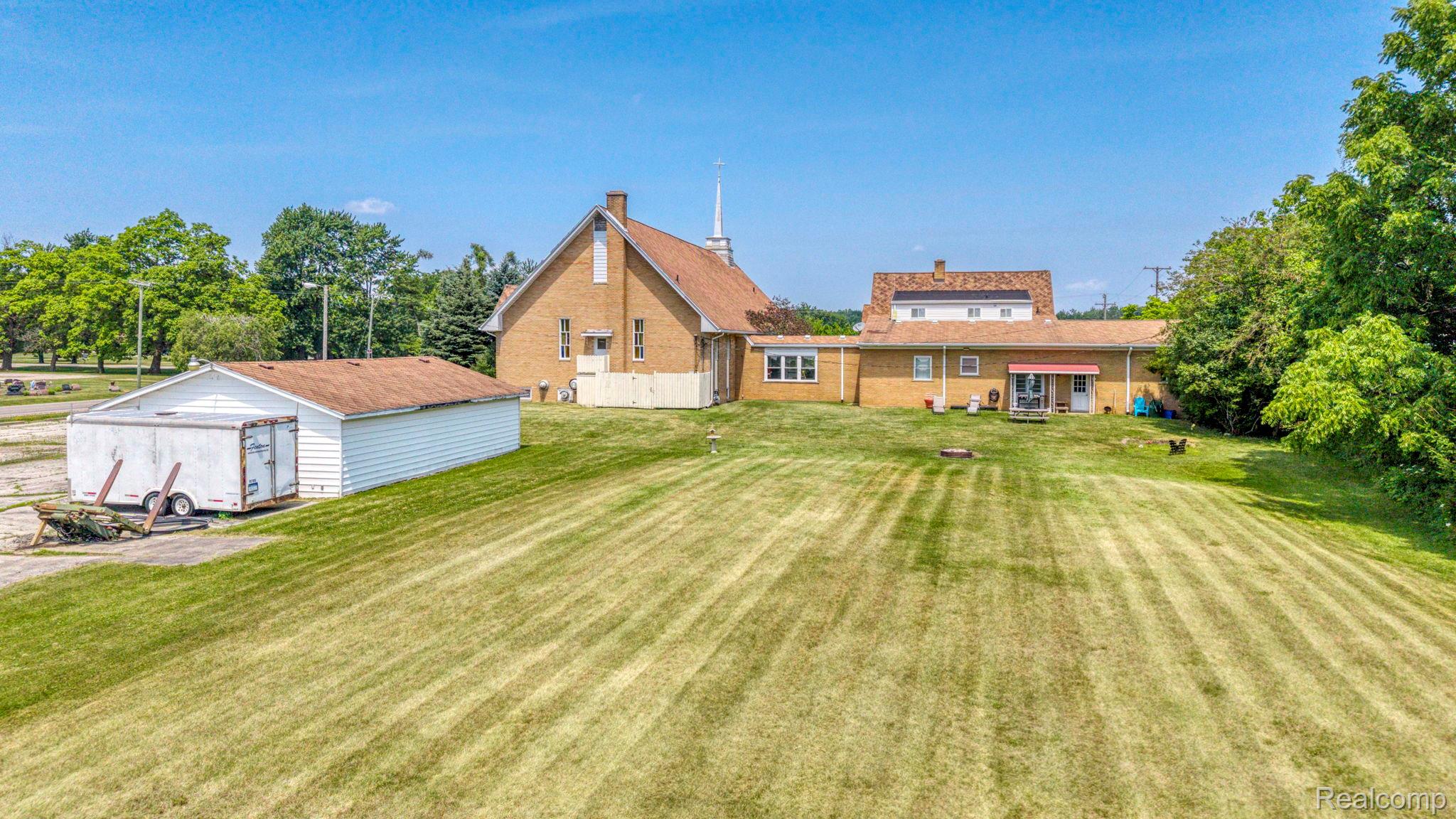 9735 Dolan Road Columbus, MI 48063 - Photo 18 of 63 Expansive green space featuring a large lawn with distinct mowing patterns