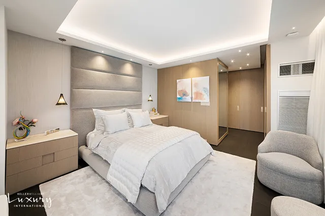 a bedroom with furniture and large windows