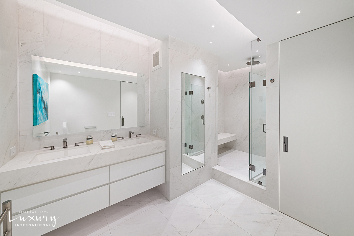 721 5th Avenue, Unit 41H Manhattan, NY 10022 - Photo 12 of 15 a bathroom with a double vanity sink mirror double and shower