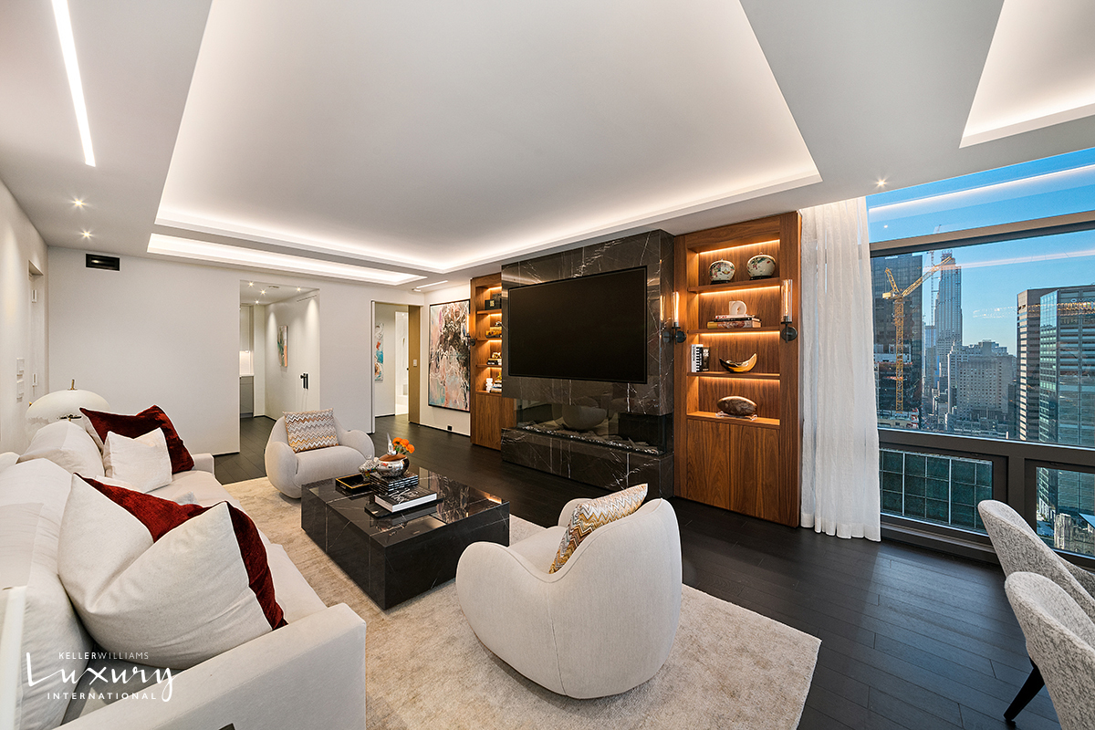 721 5th Avenue, Unit 41H Manhattan, NY 10022 - Photo 3 of 15 a living room with furniture and a flat screen tv