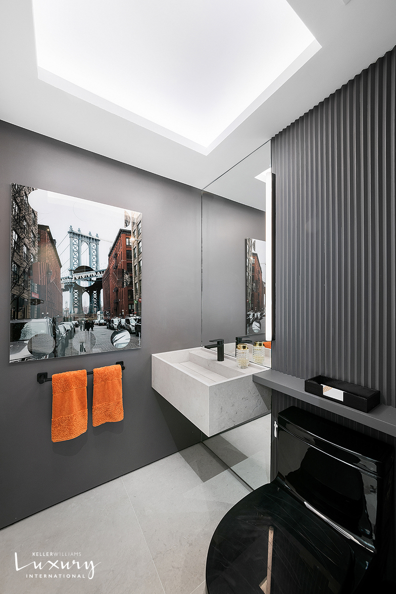 721 5th Avenue, Unit 41H Manhattan, NY 10022 - Photo 5 of 15 a room with furniture a flat screen tv and a sink