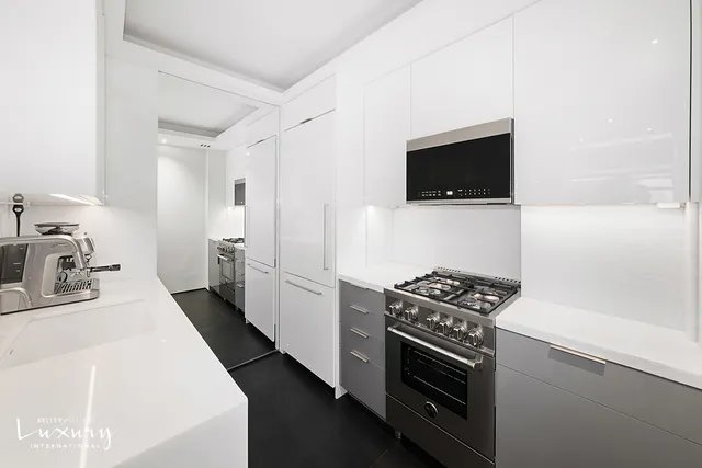 a room with furniture a flat screen tv and a sink