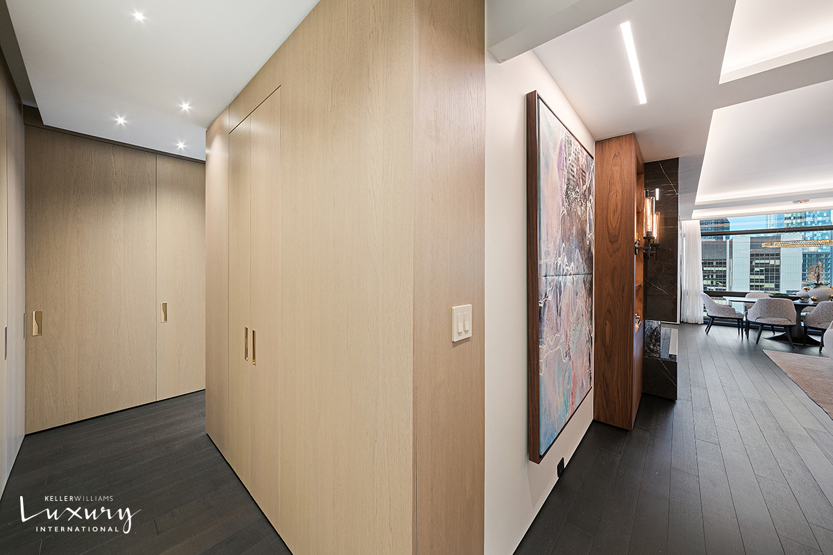 721 5th Avenue, Unit 41H Manhattan, NY 10022 - Photo 7 of 15 a view of a hallway with living room and furniture