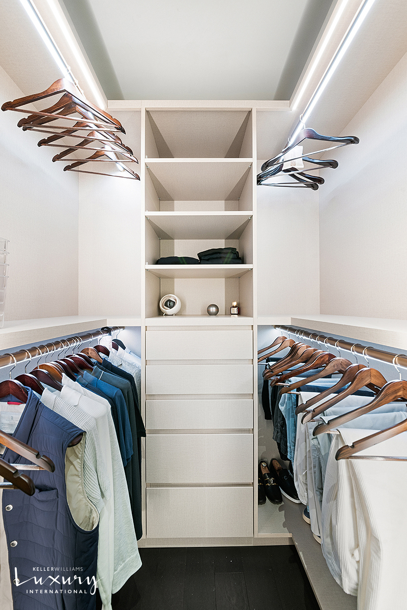 721 5th Avenue, Unit 41H Manhattan, NY 10022 - Photo 8 of 15 a view of walk in closet with clothes and shoes