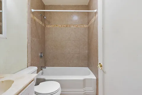 a bathroom with a toilet and a bathtub