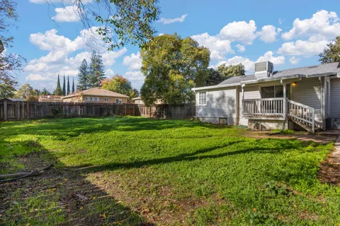 a view of a house with backyard and porch