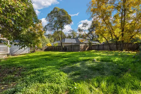 a view of house with backyard