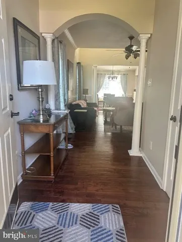 a living room with furniture and a lamp